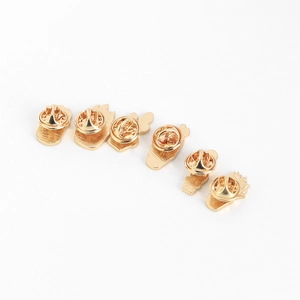 Close-up of golden butterfly clutch pin backs for enamel pins and brooches