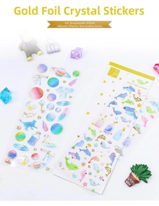 Detail of 3D crystal stickers with gold foil, featuring galaxy and dolphin patterns
