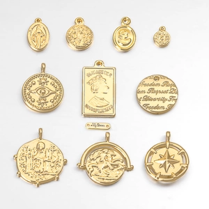 Set of ten vintage gold-plated coin pendants with embossed reliefs and engraved metal tags