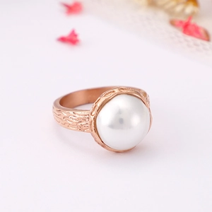 Rose gold pearl ring featuring unique hammered texture on an organic stainless steel band