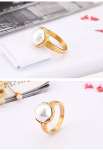 Close-up of golden bark texture ring with a large white pearl in a split-view detail