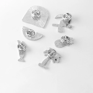 Back view of 6 tropical enamel pins with secure butterfly clasps and silver textured finish