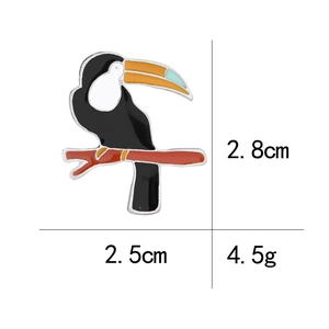 Detailed size specifications of the tropical toucan enamel brooch in white background
