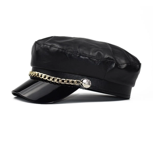Classic black PU leather baker boy hat featuring a shiny patent brim and gold chain accent