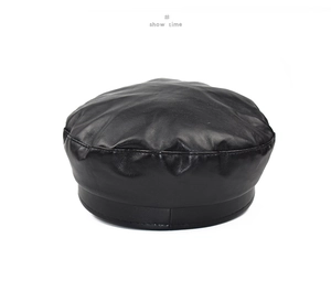 Detail view of the black PU leather beret showing fine stitching and matte texture