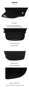 Detail of black wool newsboy hat with gold buttons and intricate brim embroidery