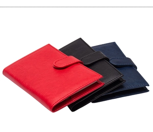 Detail of PU leather passport holders in red, black and navy with secure buckle closure