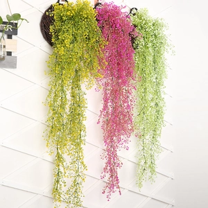 Detail of hanging artificial succulent vines in yellow, magenta, and light green colors
