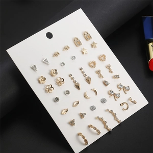 Macro detail of assorted gold and silver stud earrings with crystals on display card