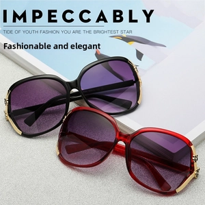 Detail of polarized sunglasses with golden metal floral embossing on gradient lens frames