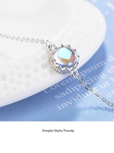 Macro shot of crown moonstone pendant with iridescent blue-violet glow on O-chain