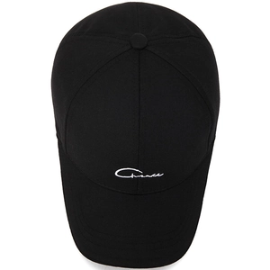 Classic black cotton baseball cap with white script embroidery in a minimalist style