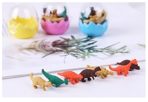 Close-up of colorful mini dinosaur erasers with transparent egg-shaped storage cases