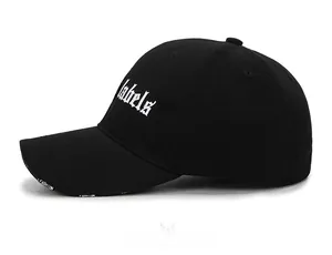 Detail view of black cotton baseball cap with Gothic Labels text and Fashion brim