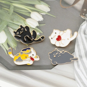 Set of four cute enamel cat pins featuring black, white, and ginger kitten designs