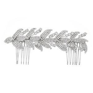 Macro view of bridal hair comb featuring silver metal leaves and sparkling rhinestones