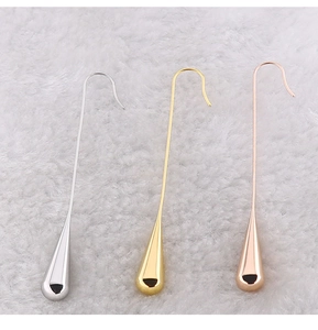 Detail of teardrop dangle earrings in silver, gold and rose gold finishes