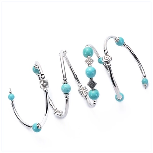 Bohemian silver bracelets set featuring turquoise beads with ornate floral engravings