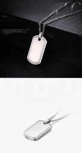 Close-up of polished stainless steel military dog tag pendant with silver mirror finish