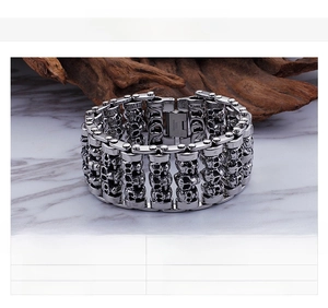 Macro detail of Kalen stainless steel skull bracelet with heavy punk chain links
