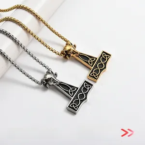 Detailed macro view of gold and silver Thor's Hammer pendants with Celtic knot motifs