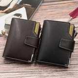 Close-up of vintage leather wallets in black and coffee with metal corner protectors