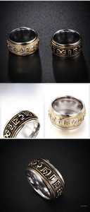 Macro view of rotating stainless steel ring featuring engraved mantras in vintage finish