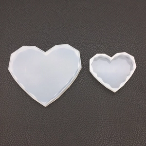 Macro detail of translucent silicone heart molds with geometric diamond cut surfaces