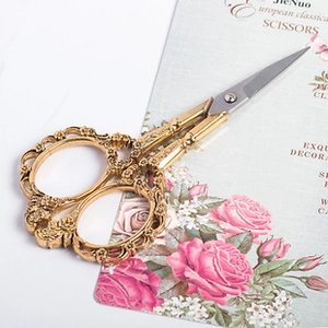 Macro detail of vintage European embroidery scissors with golden embossed handles