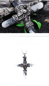 Macro detail of a gothic silver skull cross pendant necklace with black marble textures