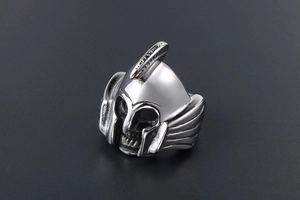 Detail of vintage silver Spartan helmet and skull titanium steel ring with aged finish