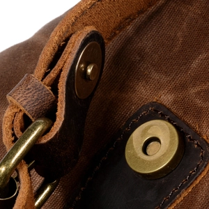 Vintage canvas and leather backpack with drawstring closure and bronze metal buckle