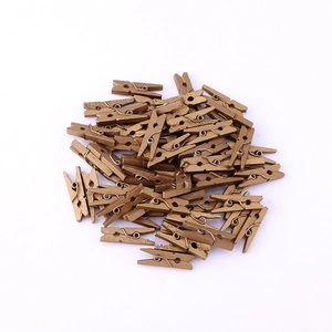 Close-up of small bronze wooden pegs with metal springs for home decor and photo displays
