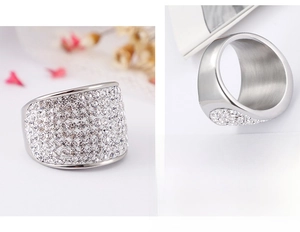 Macro detail of wide pavé set cubic zirconia ring in polished silver-tone steel