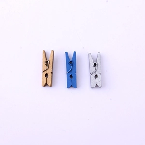 Close-up of mini gold blue and silver wooden pegs with durable metal springs
