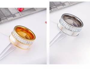 Detail of gold and silver wide band rings with shell inlay and cubic zirconia