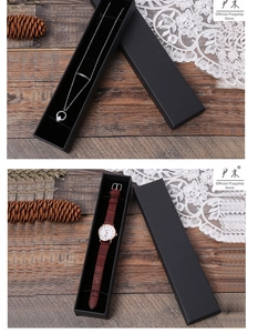 Détail de boîtes cadeaux en papier kraft noir avec ensemble collier et montre en cuir