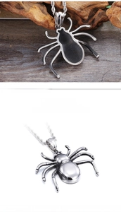 Detailed macro view of a polished stainless steel spider pendant with silver twist rope chain