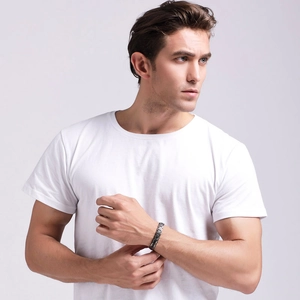Close-up of a black magnetic titanium steel therapy bracelet on a male model's wrist