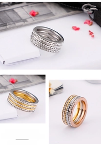 Detail of three-layer stacked rings with paved white cubic zirconia in assorted colors