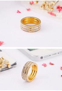 Detailed view of gold multi-layer ring featuring three rows of micro-paved white zircons