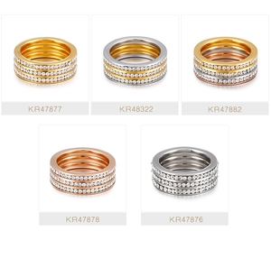 Detailed grid of wide rings in gold and silver colors with triple rows of pavé zircons