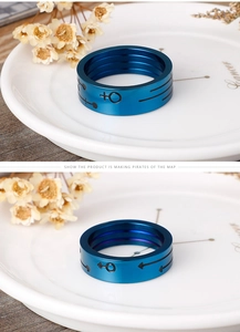 Detailed close-up of blue titanium steel couple rings with gender symbol engravings