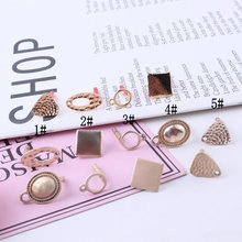 Detail of five different gold geometric DIY earring bases and jewelry pendants for craft