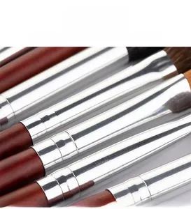 Detail of thickened silver aluminum ferrules and dark brown wooden handles of eye brushes