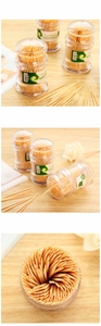 Bamboo toothpicks in transparent round containers on a natural wooden background