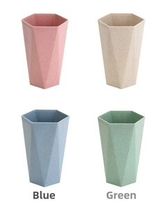Detailed view of hexagonal toothbrushes cups in pink, beige, blue and green matte tones