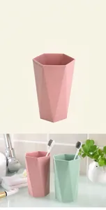Close-up of pink and green geometric mouthwash cups with a hexagonal rim design
