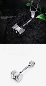 Detail of Thor hammer pendant in vintage silver with intricate Norse engravings