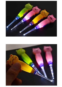 Close-up of LED illuminated cartoon animal ear picks in frog, pig, and bear shapes